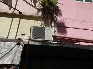 An air conditioner and a plant on the exterior of a building, Wanchai, Hong Kong Island, 14 July 2007