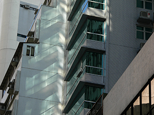 Light reflected from a building facade onto an adjoining wall, Sheung Wan,  Hong Kong Island, 19 July 2007