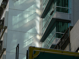 Light reflected from a building facade onto an adjoining wall, Sheung Wan, Hong Kong Island, 19 July 2007