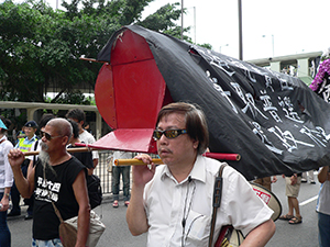 Protesters carrying a coffin in the annual pro-democracy march, 1 July 2007