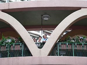 People observing from a pedestrian bridge during the annual pro-democracy march, Yee Wo Street, Causeway Bay, 1 July 2007