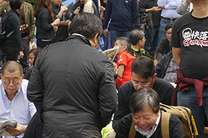 People participating in a sit-in on the final day of the Admiralty Umbrella Movement occupation site, 11 December 2014