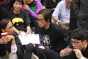 Pop singer Denise Ho, participating in a sit-in on the final day of the Admiralty Umbrella Movement occupation site, 11 December 2014