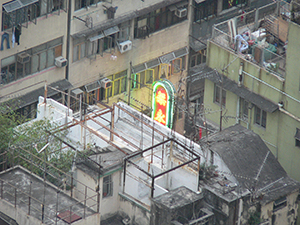 Rooftop scene with a neon sign switched on as dusk approaches, Sheung Wan, 18 October 2004