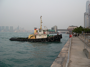 Tug boat, Victoria Harbour, with Hong Kong Macau Ferry Terminal behind, Sheung Wan, 20 October 2004