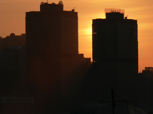 Sun setting behind the Shun Tak Centre, view from Victoria Harbour, 30 October 2004