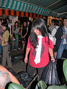 Legislative Council member Leung Kwok-hung helping a worker load refuse sacks onto his trolley, outside Club 64, Wing Wah Lane, Central, 31 October 2004