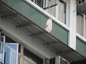 Plastic bag hanging from a window, Kowloon, 9 October 2004