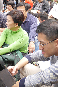 Politicians Emily Lau (left) and Lam Cheuk-ting (right), participating in a sit-in on the final day of the Admiralty Umbrella Movement occupation site, 11 December 2014