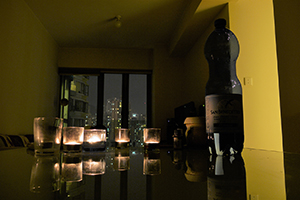 Candles and a water bottle on a table, Sheung Wan, Hong Kong Island, 8 October 2011