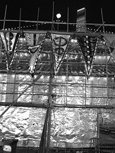 Artworks by Gaylord Chan in the form of flags, displayed on a matshed theatre at the West Kowloon Cultural District site, 18 January 2012