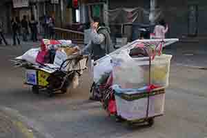 Woman with two trolleys, Sham Shui Po, 3 February 2014