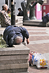 Homeless man on the street, Sheung Wan Cultural Square, 24 February 2014