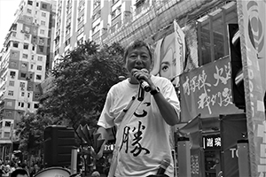 Lee Cheuk-yan, addressing crowds on their way to the annual pro-democracy march, Causeway Bay, 1 July 2014