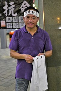 Handing out headbands before a rally at Tamar Park to launch the Occupy Central movement, 31 August 2014