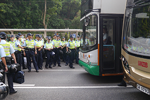 Police, and buses stopped by demonstrators sitting down on Queensway, 28 September 2014