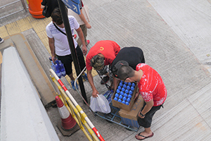 Demonstrators transporting boxes of water, Cotton Tree Drive, 28 September 2014