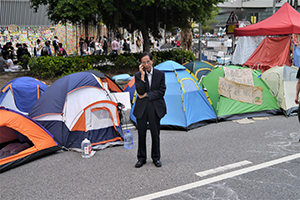 Martin Lee making a phone call, at the Admiralty Umbrella Movement occupation site, Harcourt Road, 14 October 2014