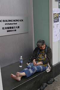 Woman asleep outside an HSBC branch near the Mongkok Umbrella Movement occupation site, Nathan Road, 26 October 2014