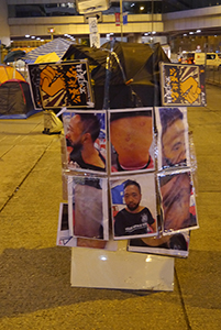 Posters showing Ken Tsang, victim of police violence, at the Admiralty Umbrella Movement occupation site, Tamar Street, 20 October 2014