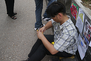 Making paper umbrellas at the Mongkok Umbrella Movement occupation site, Nathan Road, 26 October 2014