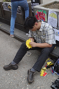 Making paper umbrellas at the Mongkok Umbrella Movement occupation site, Nathan Road, 26 October 2014