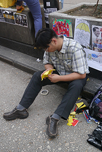 Making paper umbrellas at the Mongkok Umbrella Movement occupation site, Nathan Road, 26 October 2014