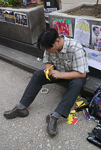 Making paper umbrellas at the Mongkok Umbrella Movement occupation site, Nathan Road, 26 October 2014