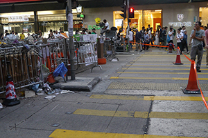 Protester-build barricade adjacent to a police roadblock at the Mongkok Umbrella Movement occupation site, Nathan Road, 26 October 2014