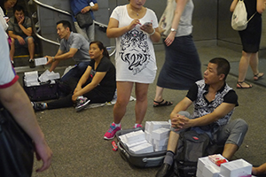 Traders selling iPhones on an overhead walkway near the Apple Store, Central, 1 October 2014