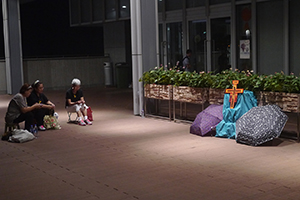 Umbrellas and  a crucifix, placed outside the Central Government Offices Complex, 2 October 2014