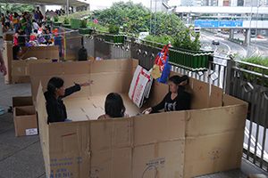 Foreign domestic helpers gathering on an overhead walkway on their day off, Central, 2 November 2014