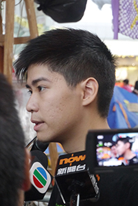 Student leader Lester Shum being interviewed at the Admiralty Umbrella Movement occupation site, Harcourt Road, 2 November 2014