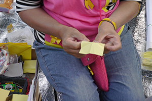 Woman making paper umbrellas at the Admiralty Umbrella Movement occupation site, Harcourt Road, 15 November 2014