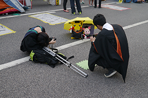 People taking graduation photos at the Admiralty Umbrella Movement occupation site, Harcourt Road, 15 November 2014
