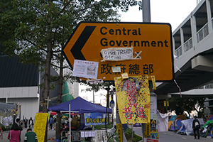 Posters on a road sign at the Admiralty Umbrella Movement occupation site, Tim Mei Avenue, 15 November 2014