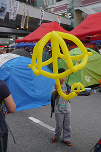 Child with a balloon umbrella, Harcourt Road, Admiralty, 2 November 2014