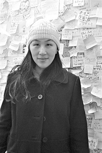 Artist Yuk King Tan in front of the Lennon Wall at the Admiralty Umbrella Movement occupation site, Harcourt Road, 10 December 2014