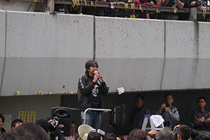 Leung Kwok-hung participating in a sit-in on the final day of the Admiralty Umbrella Movement occupation site, Harcourt Road, 11 December 2014