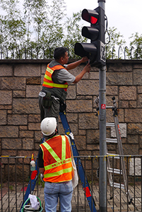 Removing a sticker from a traffic light, on the final day of the Admiralty Umbrella Movement occupation site, Harcourt Road, 11 December 2014