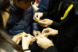 Making origami umbrellas at the Causeway Bay Umbrella Movement occupation site, Yee Wo Road, 14 December 2014