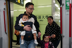 People entering an MTR train at the newly-opened HKU Station, Pokfulam, 28 December 2014
