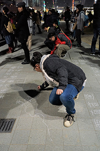 Drawing protest graffiti, Tamar Park, Admiralty, 1 January 2015