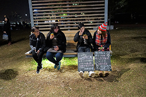 People sitting on a bench, Tamar Park, Admiralty, 1 January 2015