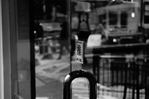 Reflection of street view on the door of a shop, Aberdeen Street, Hong Kong Island, 24 January 2015