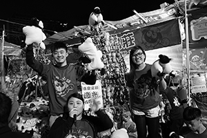 Young people selling goods at a booth in the Lunar New Year Fair, Victoria Park, Causeway Bay, 18 February 2015