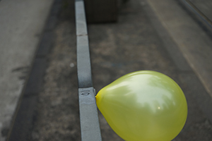 A yellow balloon tied to a railing during the pro-democracy march from Victoria Park to Central, Queensway, 1 February 2015