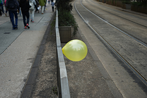 A yellow balloon tied to a railing, during a pro-democracy march from Victoria Park to Central, Queensway, 1 February 2015