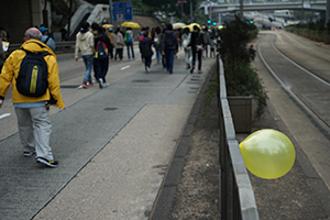 A yellow balloon tied to a railing, during a pro-democracy march from Victoria Park to Central, Queensway, 1 February 2015