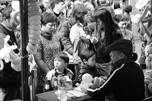 Adults and children waiting for balloons at Sheung Wan Cultural Square, Bonham Strand, 1 February 2015